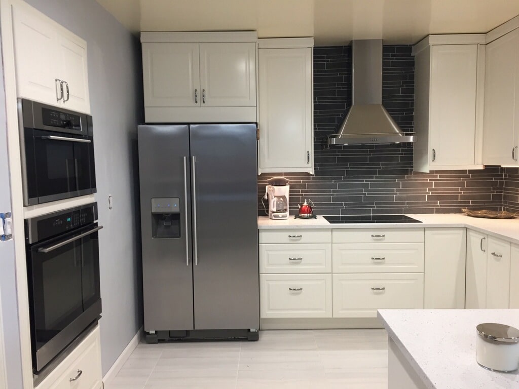 Norstone Ash Grey Lynia Interlocking Tile used on a backsplash application with a prominent stainless steel vent hood